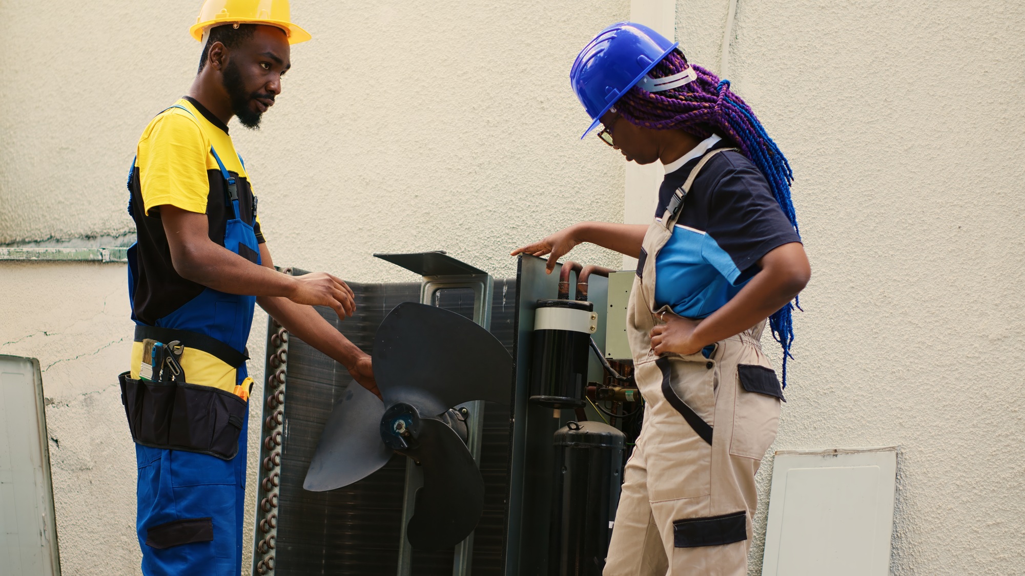 Colleagues opening up faulty hvac system